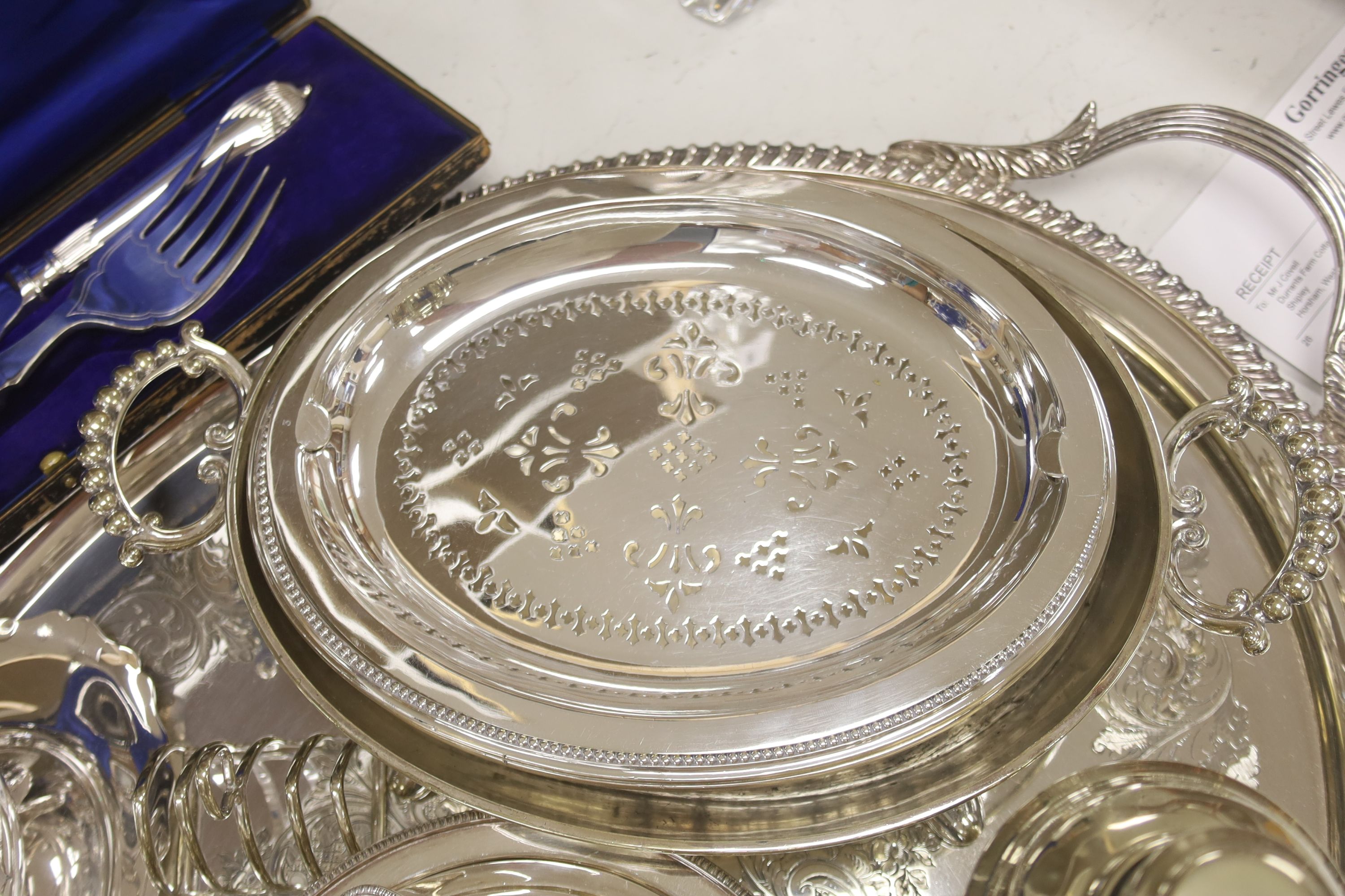 A collection of silver-plated wares to include an oval drinks tray, a cocktail shaker, serving tureens, etc.